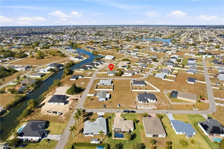 Aerial view of property's location with nearby suburban area and a large body of water