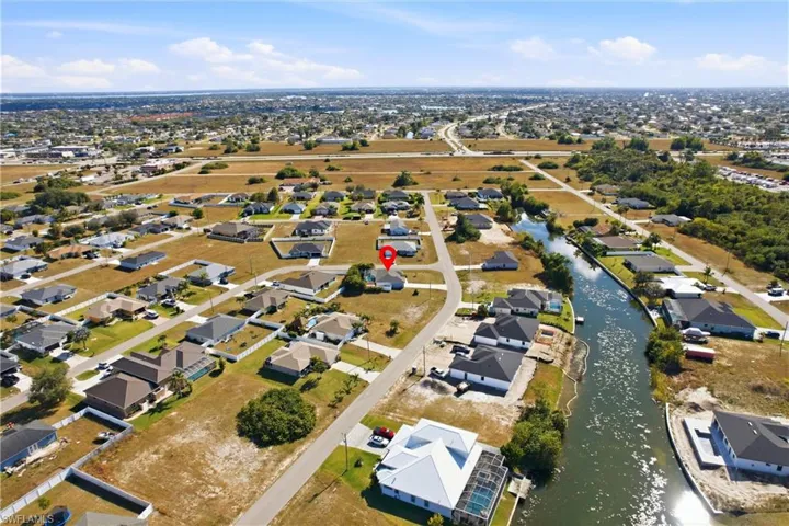 Aerial view of property's location featuring nearby suburban area and a nearby body of water