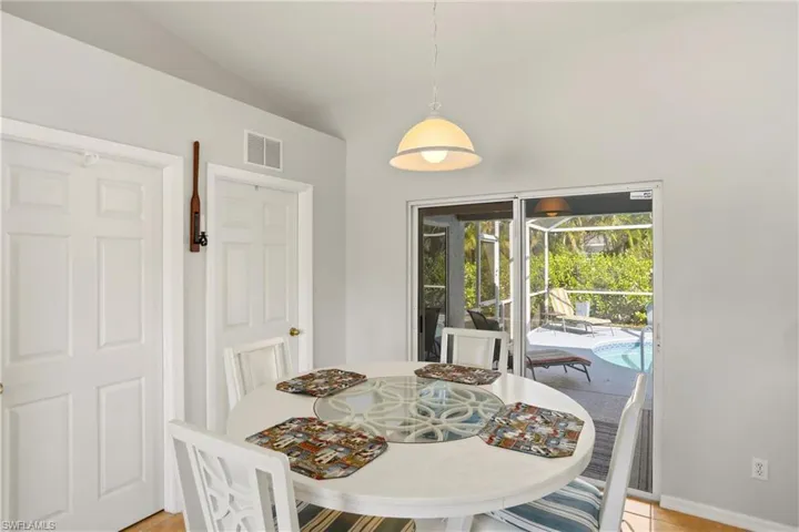 Dining area featuring vaulted ceiling