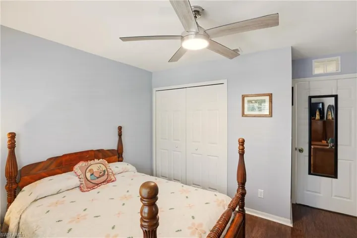 Bedroom featuring a ceiling fan, a closet, and wood finished floors