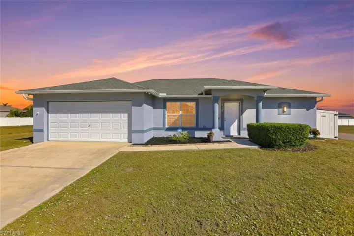View of front of house with stucco siding, concrete driveway, a shingled roof, and an attached garage