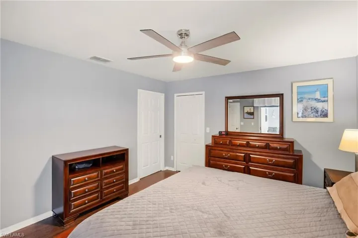 Bedroom featuring dark wood-style flooring and a ceiling fan