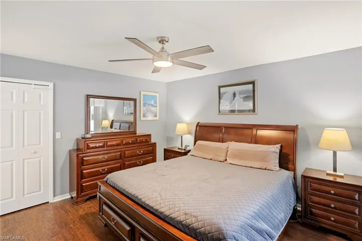 Bedroom featuring a closet, dark wood-type flooring, and a ceiling fan