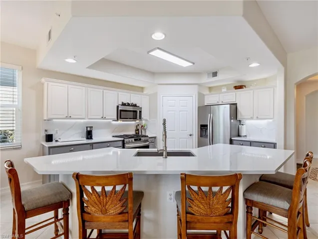 Kitchen with tasteful Quartz backsplash,