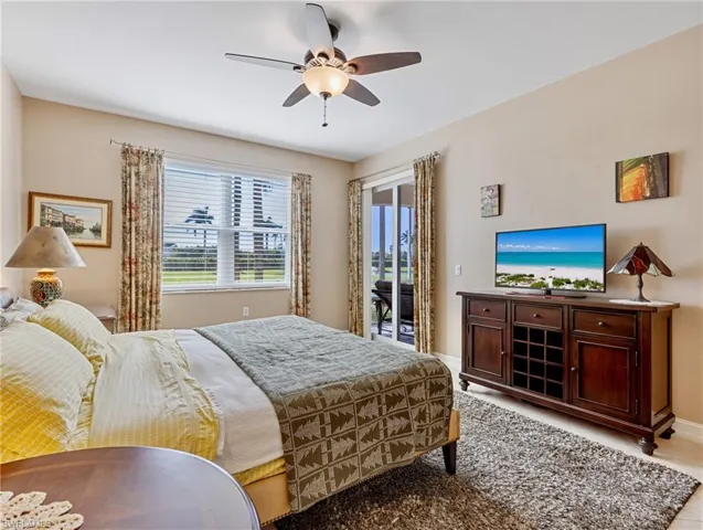 Bedroom featuring access to exterior, ceiling fan
