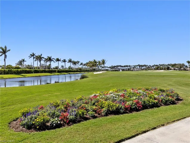 View of community featuring a water view and a lawn
