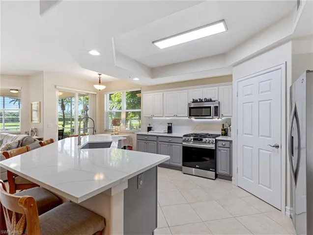 Kitchen featuring island with sink
