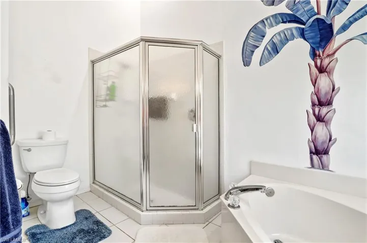 Full bath featuring a bath, tile patterned flooring, and a stall shower
