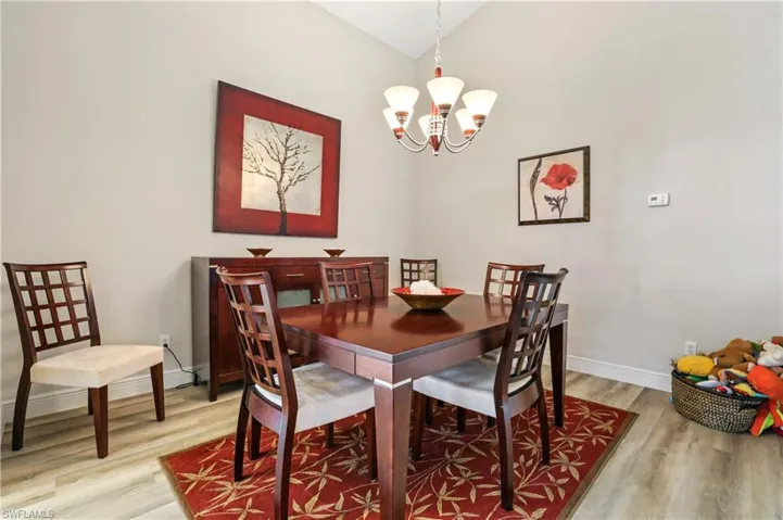 Dining space with a chandelier and light wood-style floors