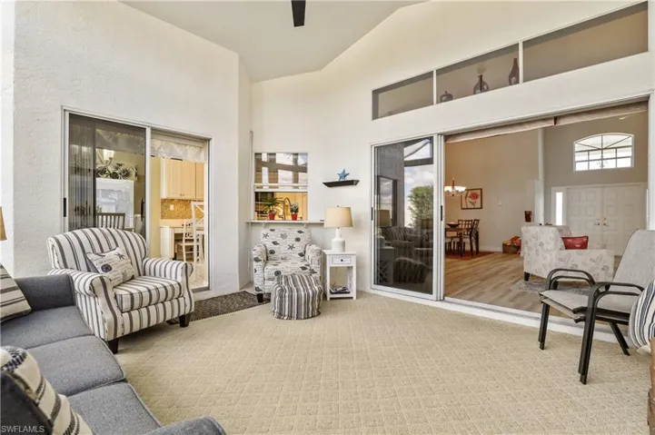 Carpeted living area with a high ceiling
