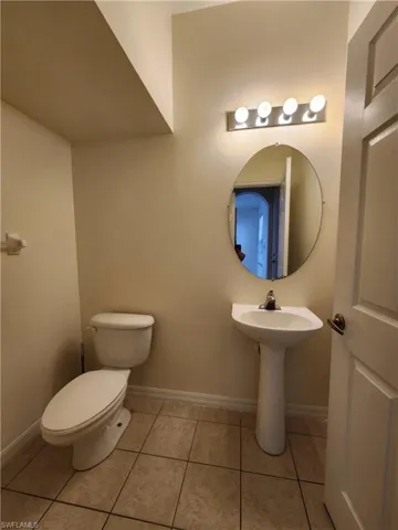 Bathroom with toilet and light tile patterned floors