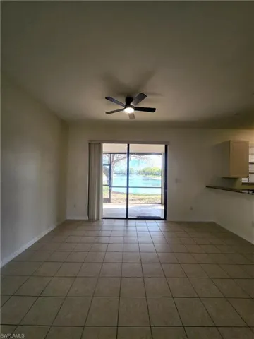 Unfurnished room with a ceiling fan and light tile patterned floors