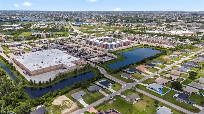 Birds eye view of property with a water view
