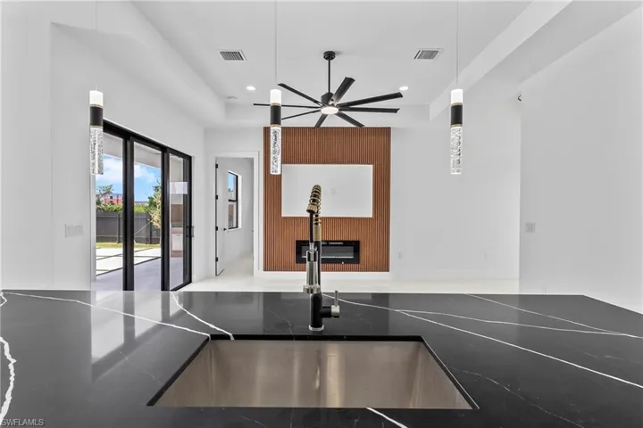 Kitchen featuring sink, ceiling fan, and decorative light fixtures
