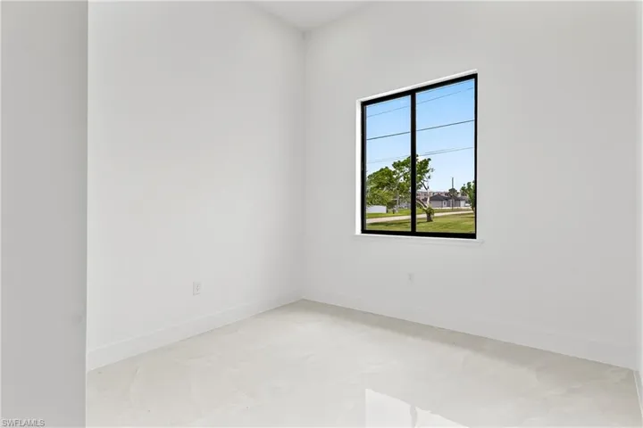 Empty room featuring light tile patterned floors