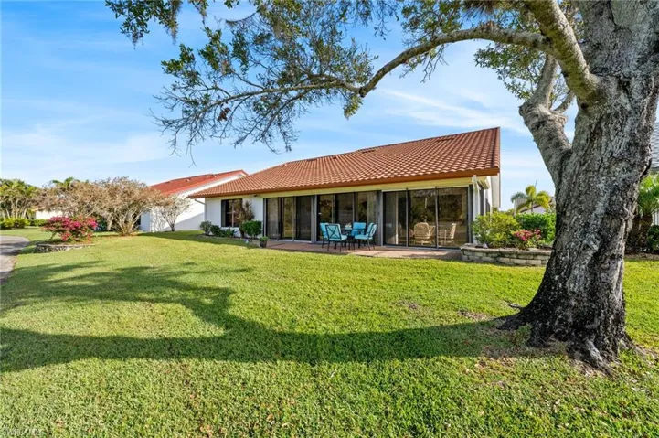 Back of house with a yard
