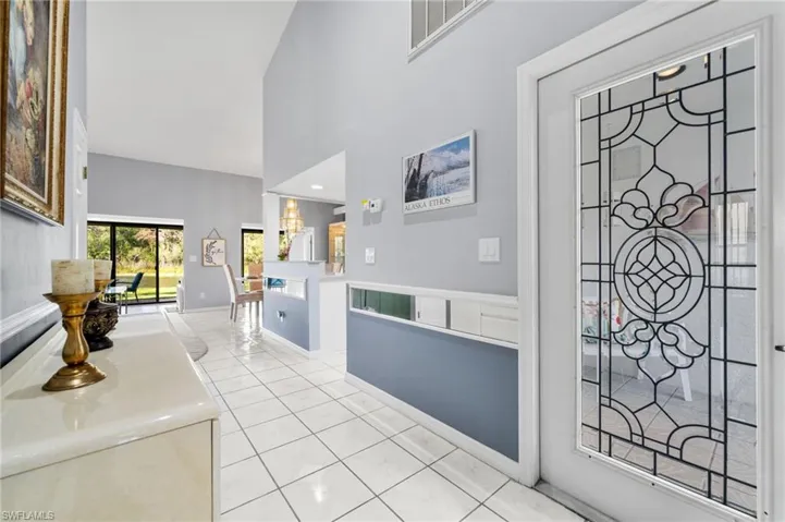 Tiled foyer entrance with vaulted ceiling