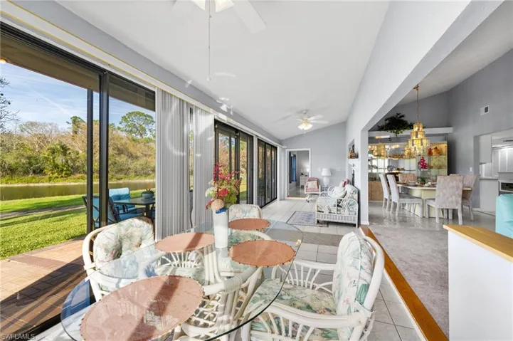 Sunroom / solarium with vaulted ceiling, ceiling fan, and a healthy amount of sunlight