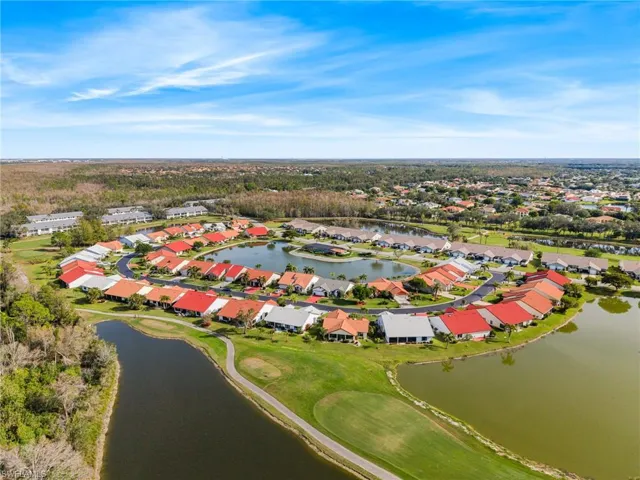 Birds eye view of property with a water view