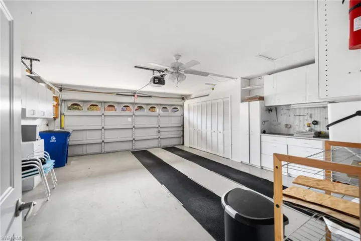 Garage with ceiling fan and a garage door opener