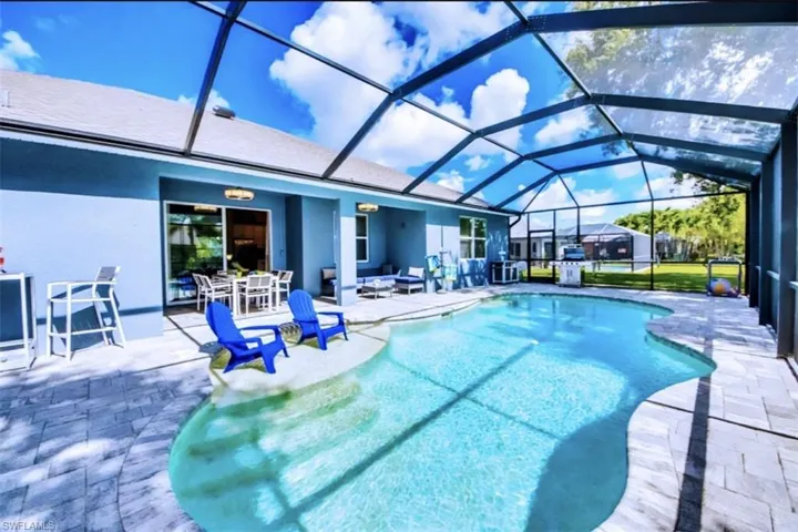 Outdoor pool featuring a patio, a sunroom, a lanai, outdoor dining area, and outdoor lounge area