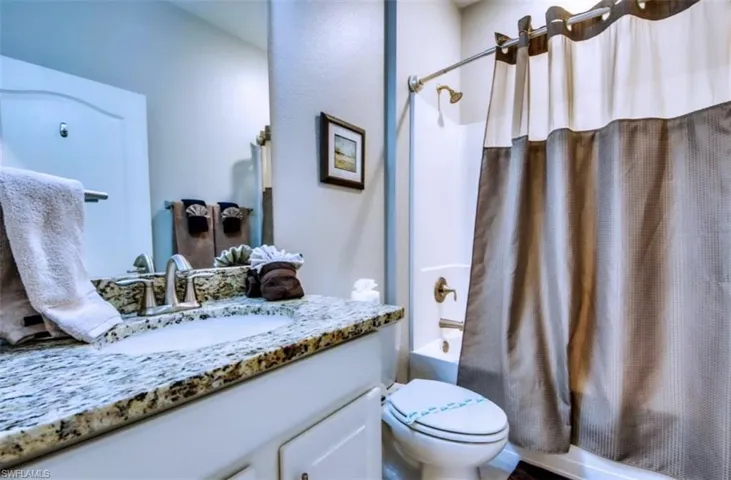 Bathroom with shower / bath combo and vanity
