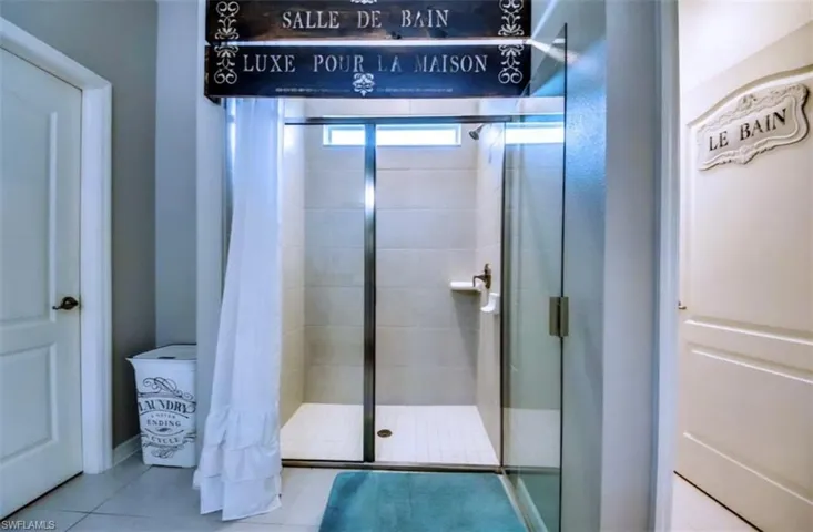 Full bath featuring tile patterned floors and a stall shower
