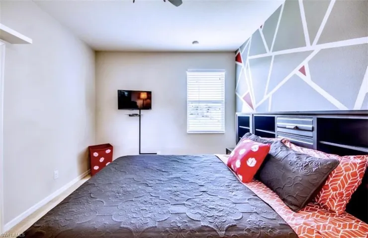 Bedroom with ceiling fan and baseboards