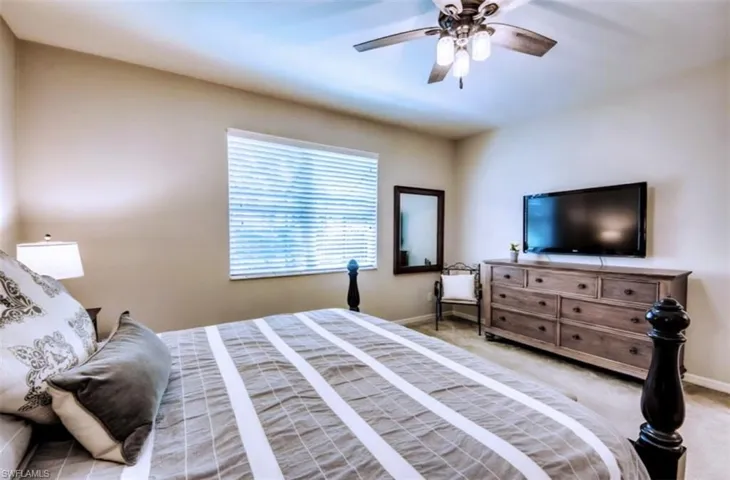 Bedroom featuring light colored carpet and ceiling fan