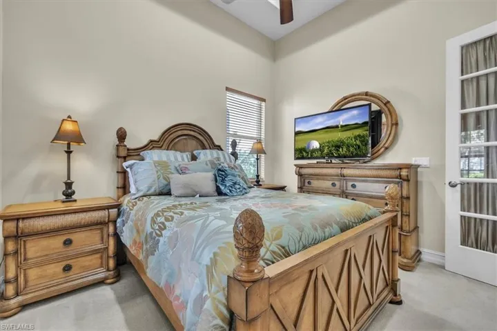 Bedroom featuring light colored carpet and ceiling fan