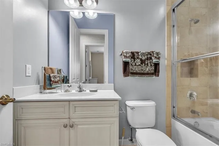 Full bathroom featuring bath / shower combo with glass door and vanity