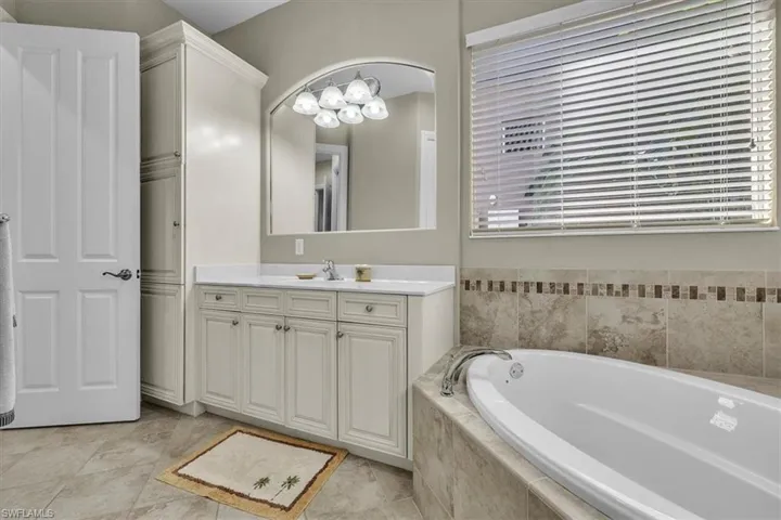 Full bathroom featuring vanity and a bath