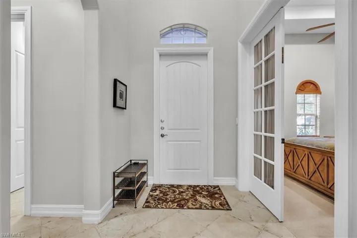 Entrance foyer featuring baseboards and a ceiling fan