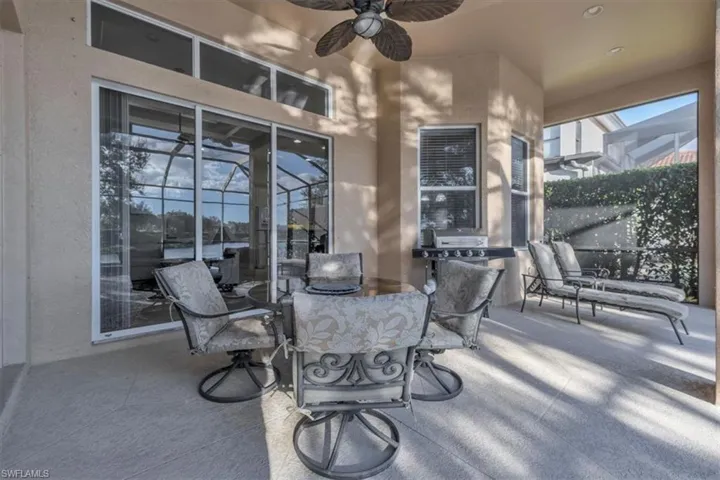 View of patio / terrace with a ceiling fan, outdoor dining area, and a grill