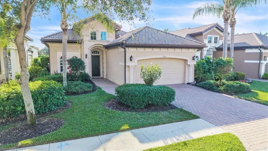 View of front of house featuring stucco siding, decorative driveway, an attached garage, and a tiled roof