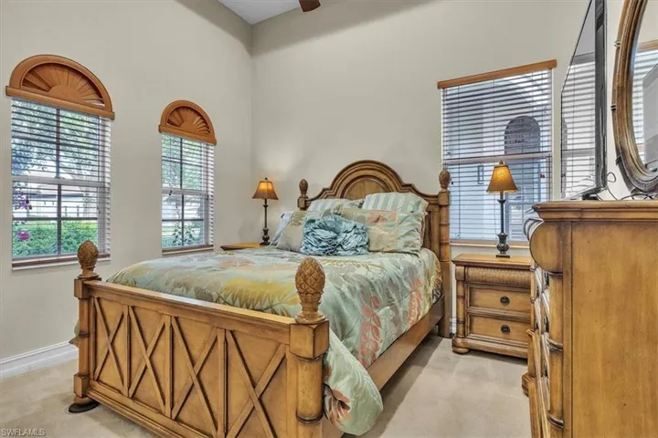 Bedroom with ceiling fan and light colored carpet