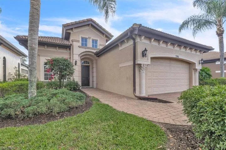 Mediterranean / spanish-style house featuring an attached garage, stucco siding, a tiled roof, and decorative driveway