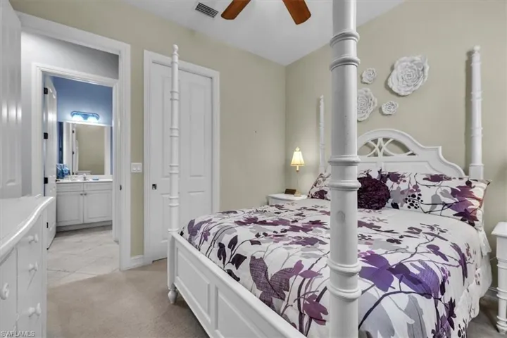 Bedroom with light colored carpet and ceiling fan