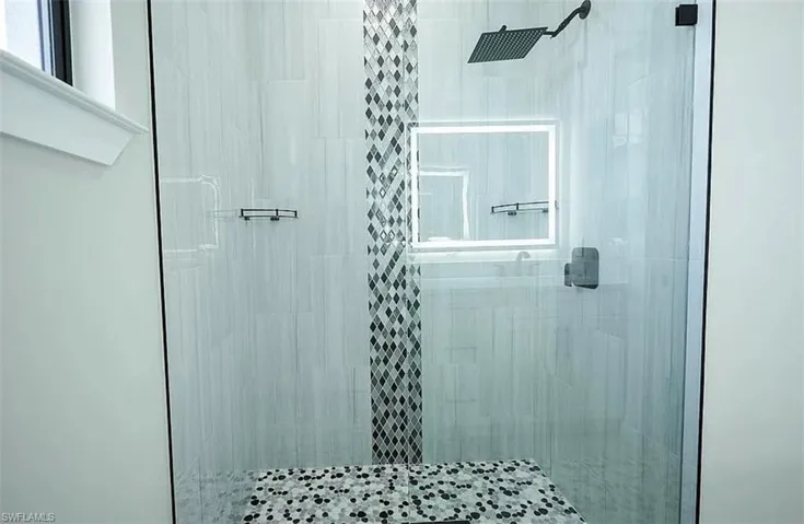 Bathroom with a shower with shower door