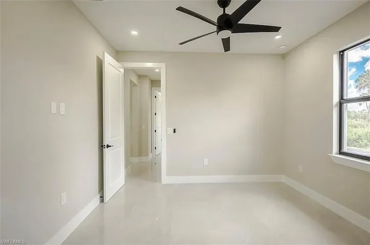 Spare room featuring a wealth of natural light and ceiling fan
