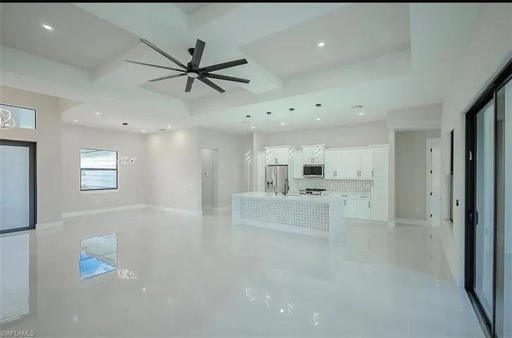 Unfurnished living room with ceiling fan