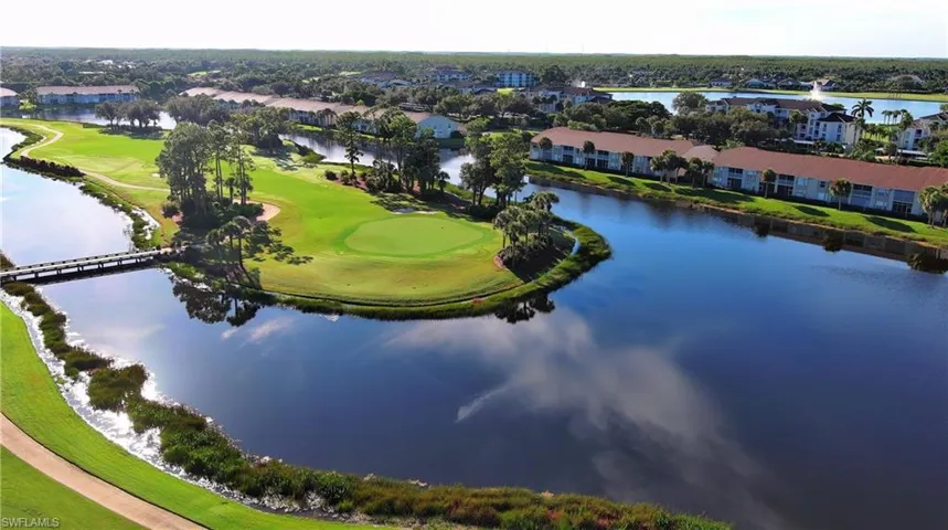 Aerial view of property's location featuring a large body of water and a local golf course