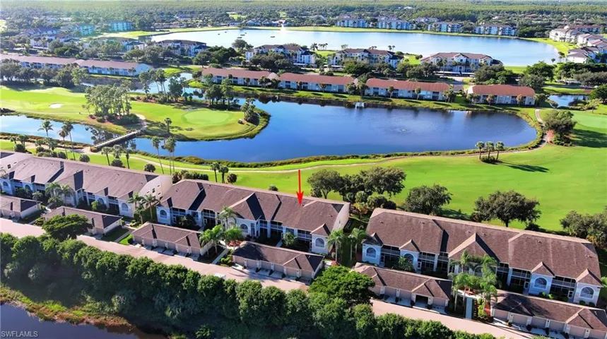 Aerial view of residential area with a large body of water and a local golf course