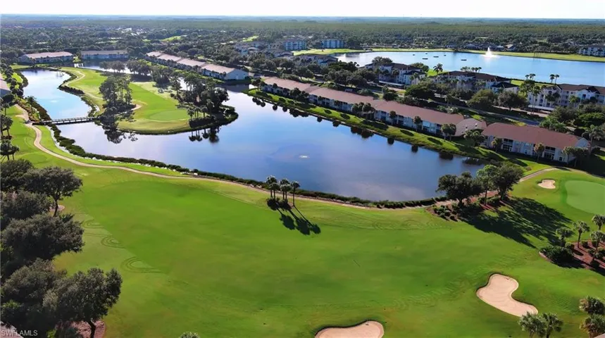 Aerial perspective of suburban area with a local golf course and a nearby body of water