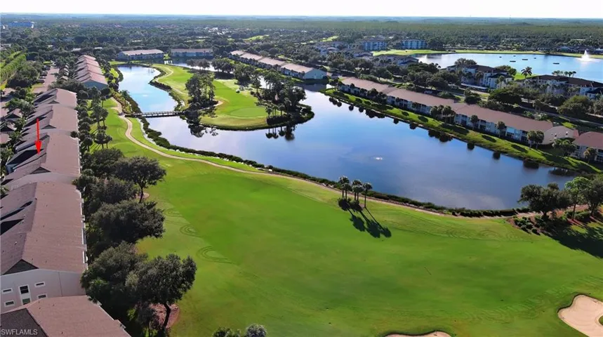 Aerial perspective of suburban area with a golf club and a nearby body of water