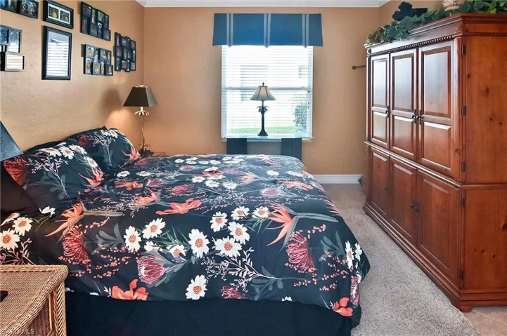 Bedroom featuring light colored carpet and ornamental molding