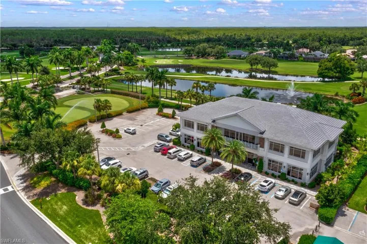Drone / aerial view of a nearby body of water and a golf course