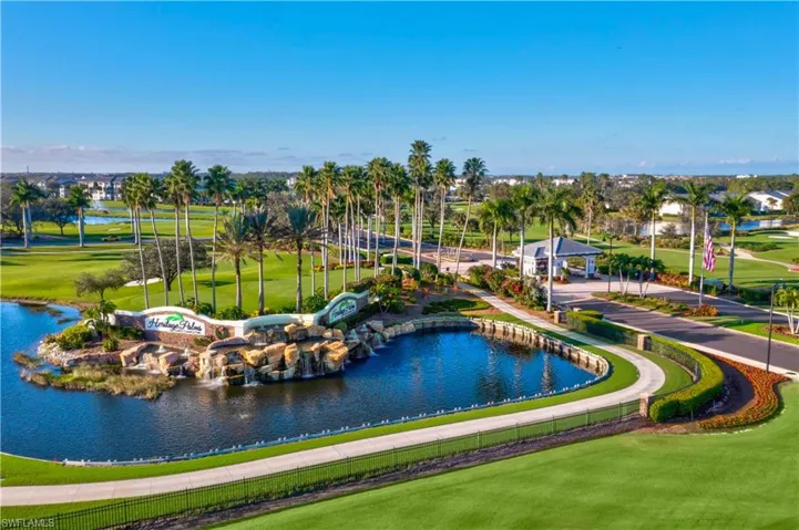 View of property's community featuring view of golf course, a yard, and a water view