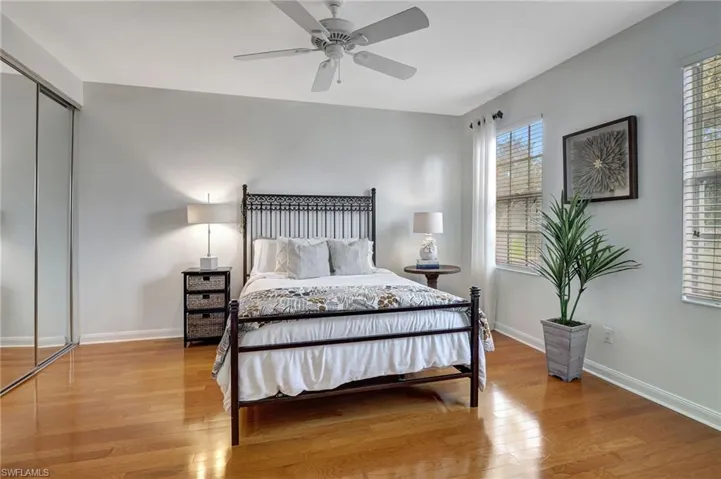 Bedroom featuring light hardwood / wood-style floors, ceiling fan, and a closet
