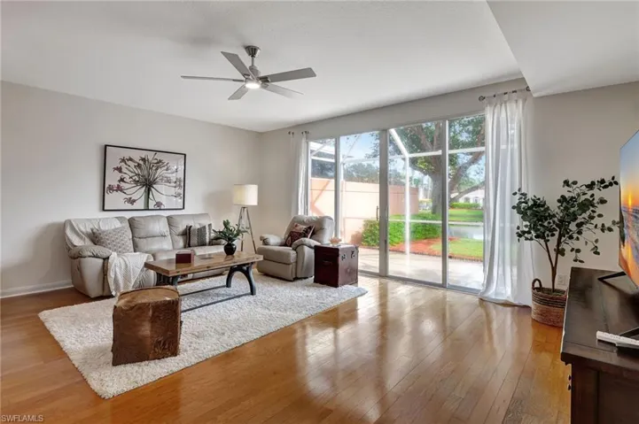 Living room featuring light wood-type flooring and ceiling fan